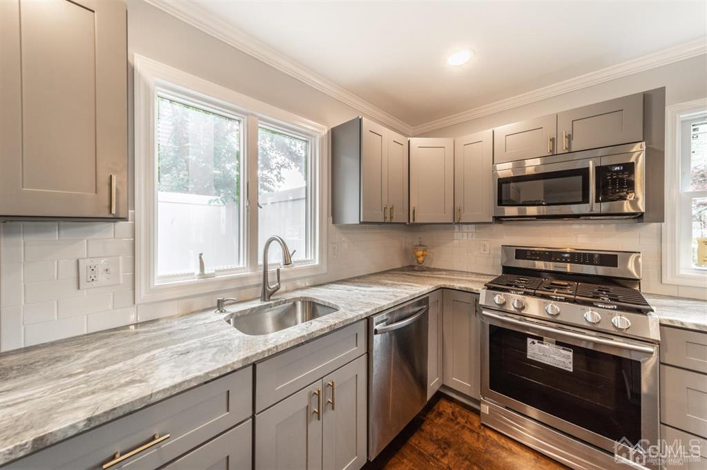 107 Winthrop Road Edison, NJ 08817 - Photo 10 of 38 a kitchen with granite countertop a sink and steel appliances