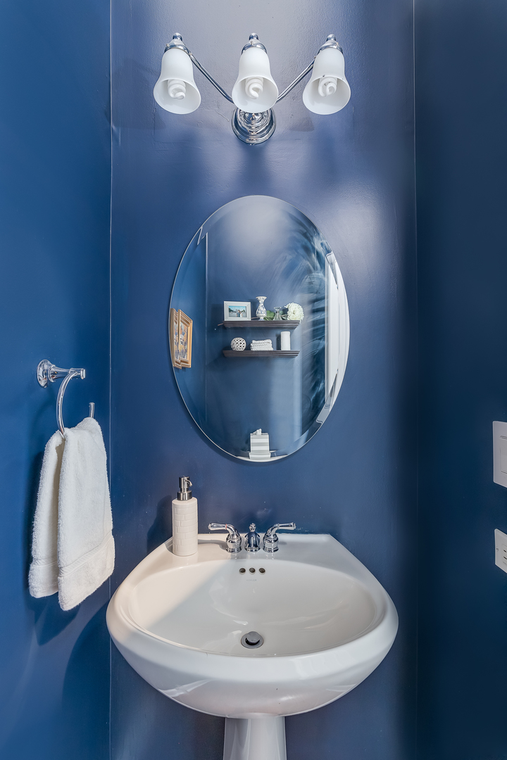 847 North May Street Chicago, IL 60642 - Photo 12 of 32 a bathroom with a sink and a mirror