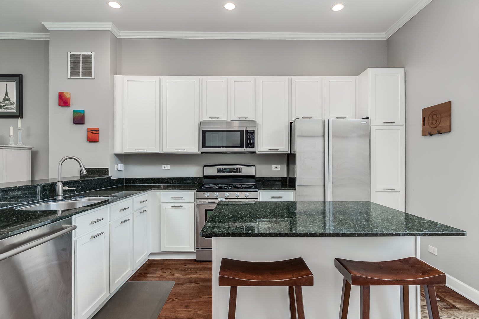 847 North May Street Chicago, IL 60642 - Photo 14 of 32 a kitchen with stainless steel appliances granite countertop a stove a sink and a refrigerator