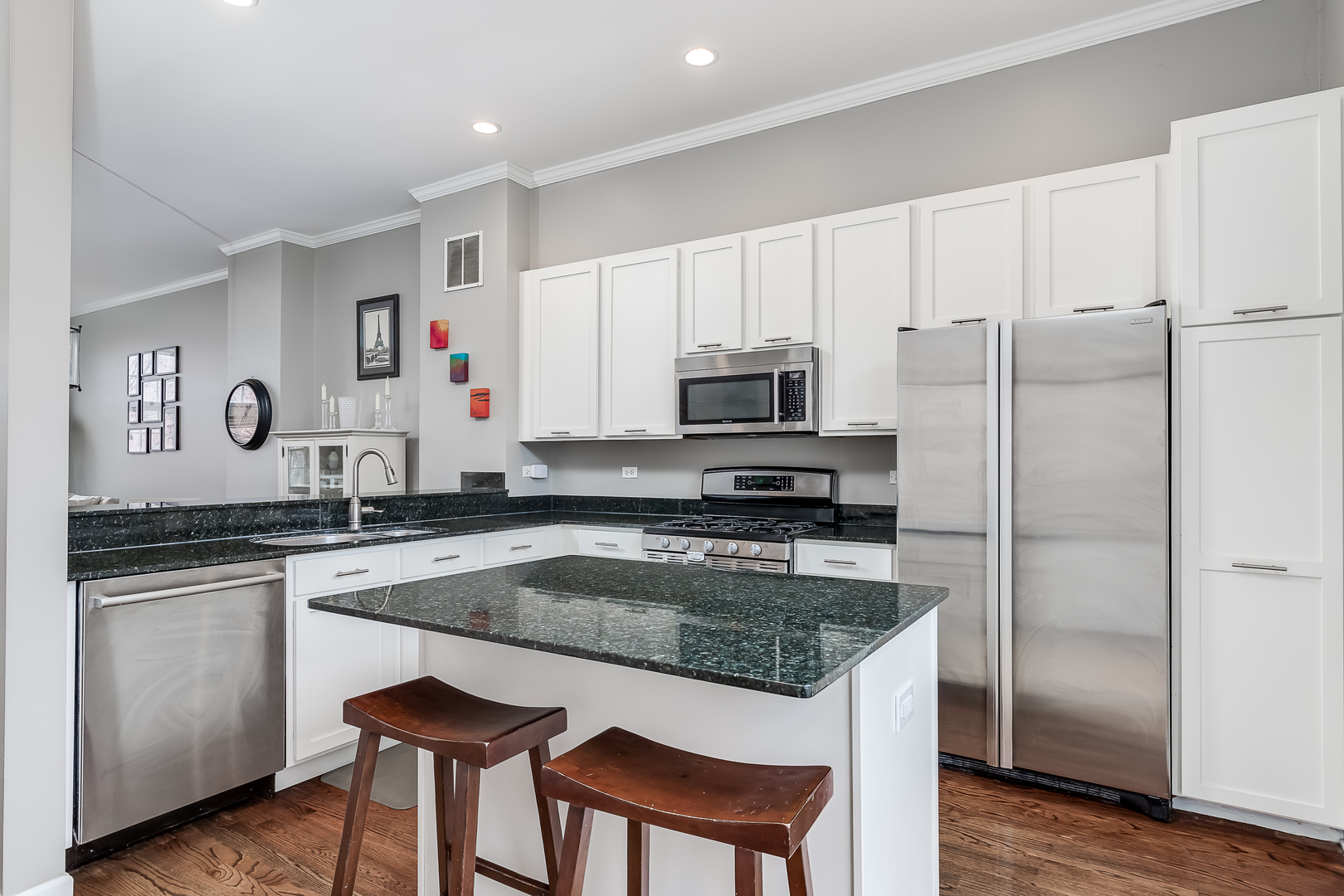 847 North May Street Chicago, IL 60642 - Photo 15 of 32 a kitchen with stainless steel appliances granite countertop a sink stove and refrigerator