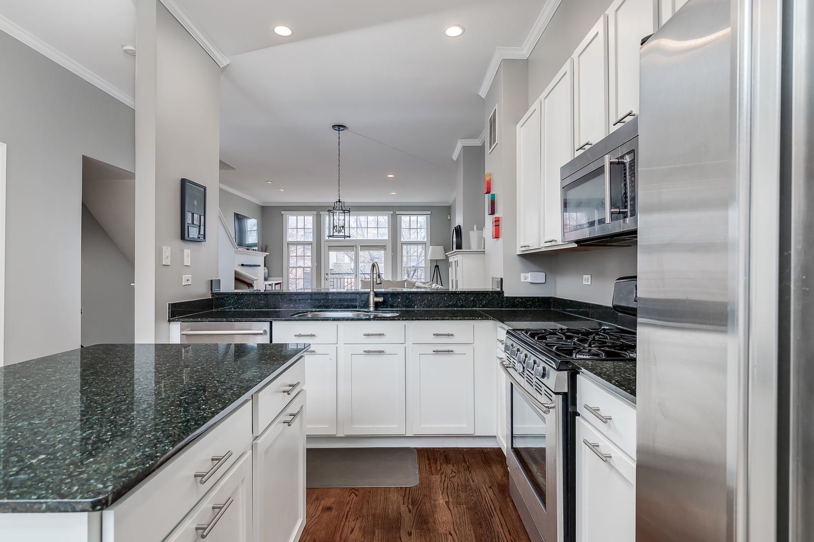 847 North May Street Chicago, IL 60642 - Photo 17 of 32 a kitchen with stainless steel appliances granite countertop a stove a sink and a refrigerator