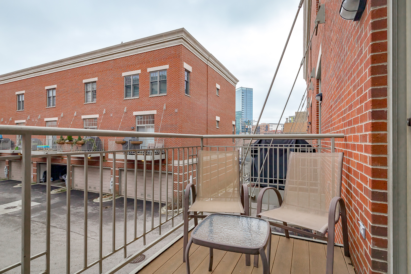 847 North May Street Chicago, IL 60642 - Photo 18 of 32 a balcony view with two chairs and wooden fence