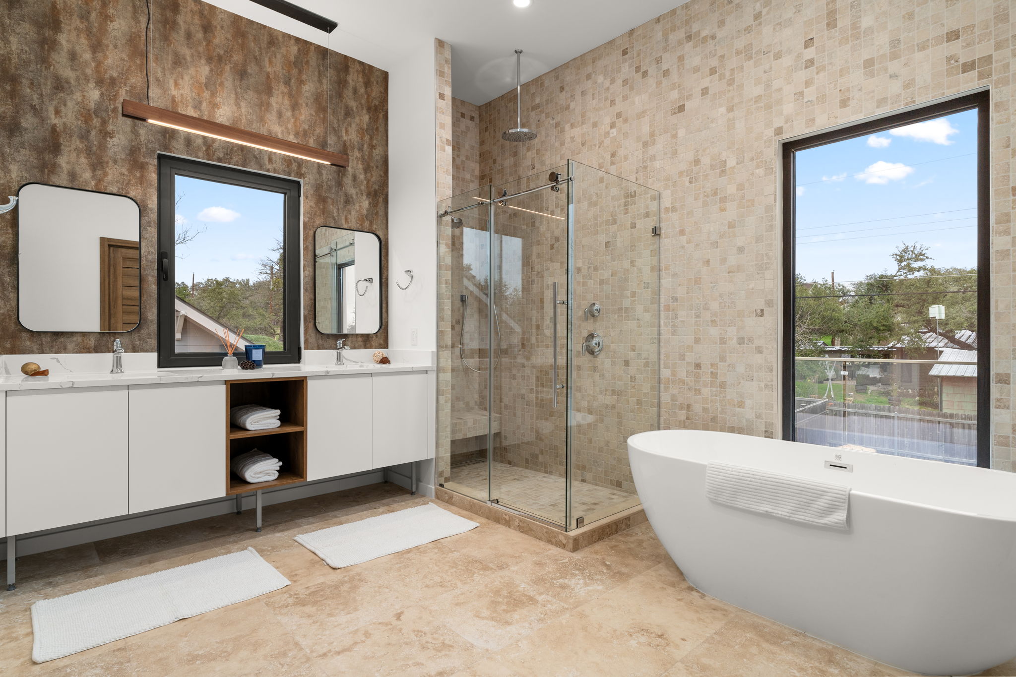 2915 Chisholm Trail Austin, TX 78734 - Photo 22 of 35 a bathroom with a double vanity sink a mirror and a bathtub