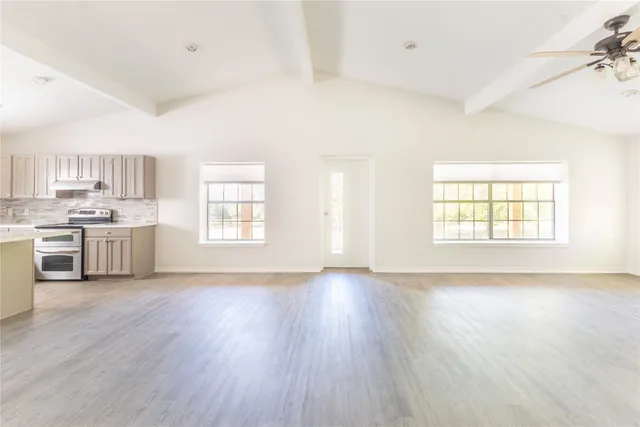 a view of a kitchen with a sink wooden floor and a window