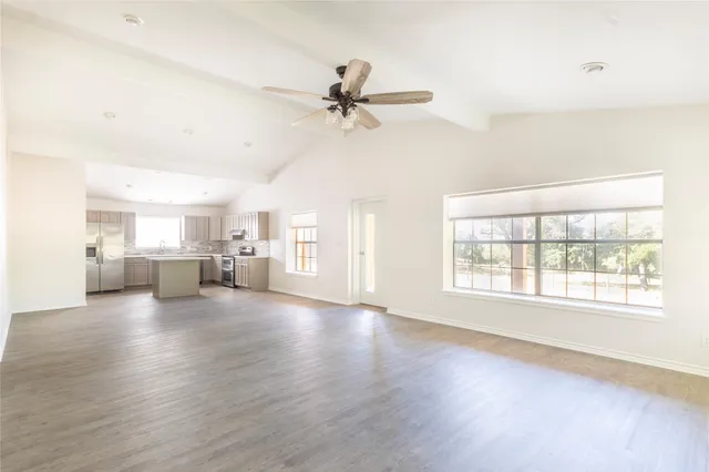 a view of a livingroom with furniture ceiling fan and window