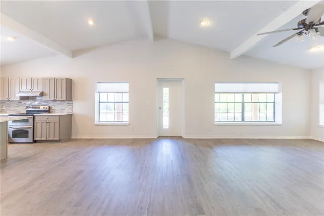 a view of kitchen with a sink wooden floor and windows