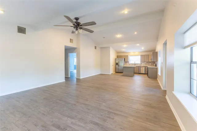 a view of a kitchen with a sink and a stove top oven