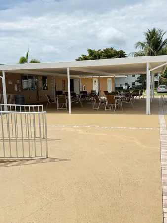 an outdoor space with swimming pool and furniture