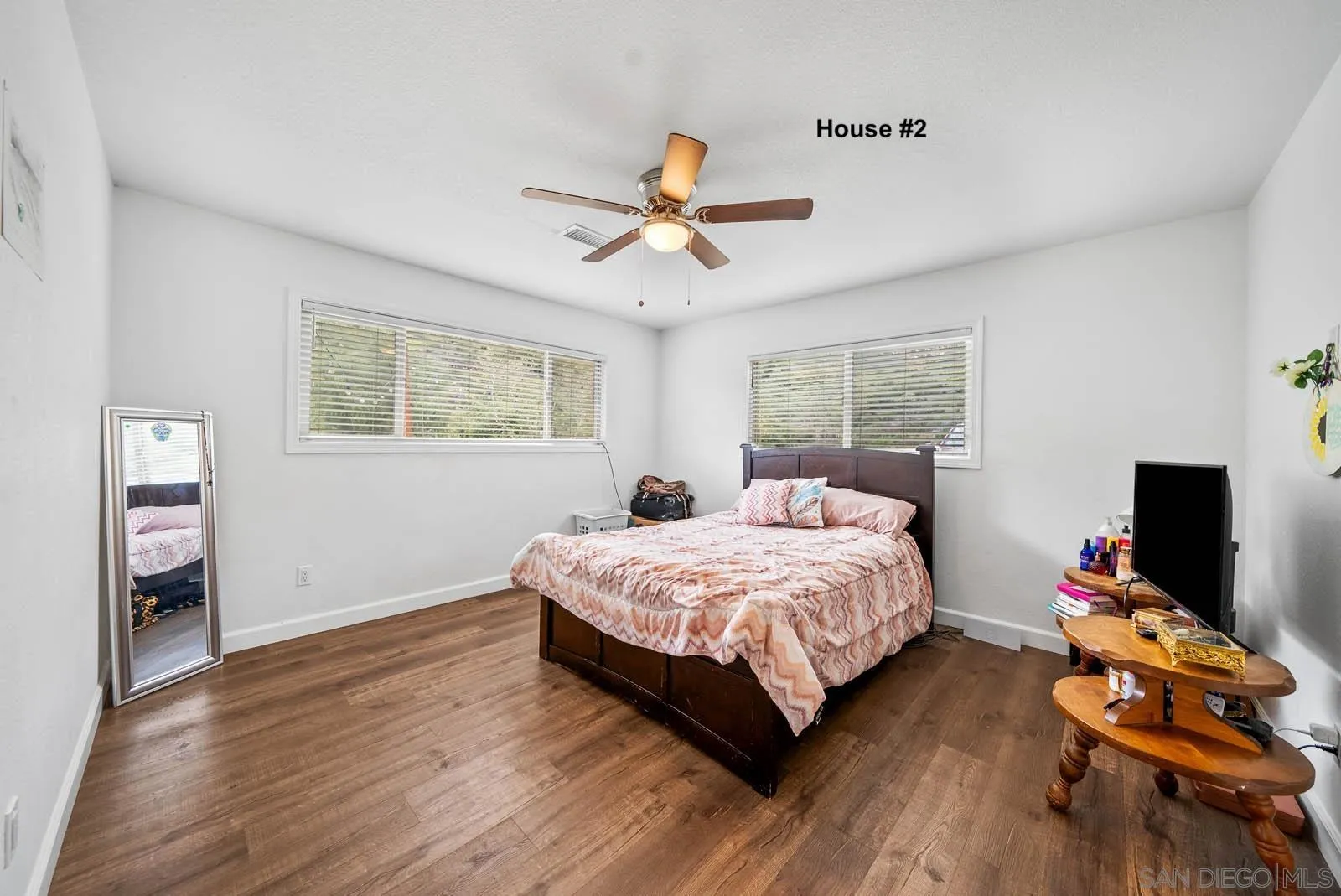 21908 Japatul Lane Alpine, CA 91901 - Photo 26 of 47 a bedroom with a bed and wooden floor