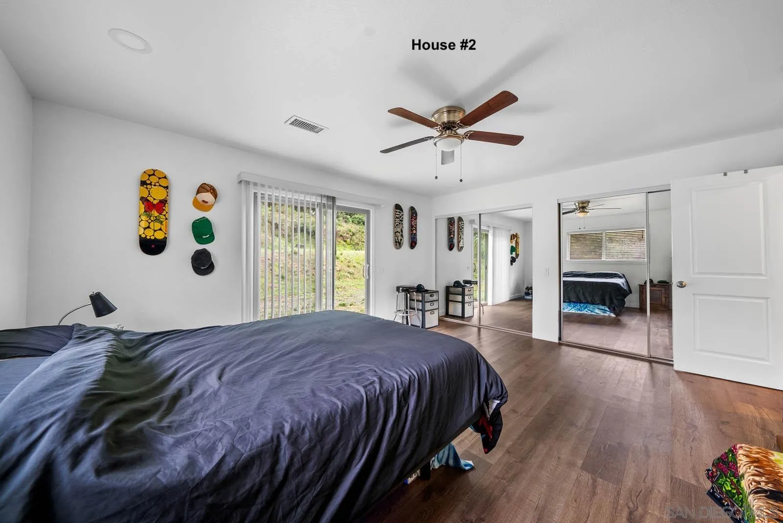 21908 Japatul Lane Alpine, CA 91901 - Photo 28 of 47 a bedroom with a large bed and a chandelier