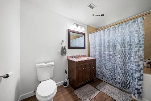 a bathroom with a toilet a sink and mirror