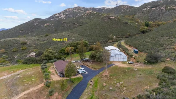 an aerial view of residential houses with outdoor space