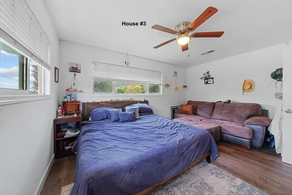 a bedroom with a bed couch and window