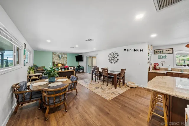 a view of a dining room with furniture and chandelier