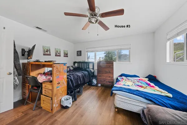 a bedroom with furniture and a wooden floor