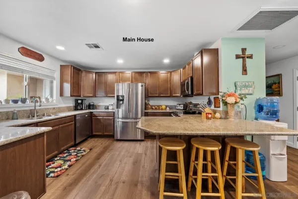 a kitchen with stainless steel appliances granite countertop a sink stove and refrigerator