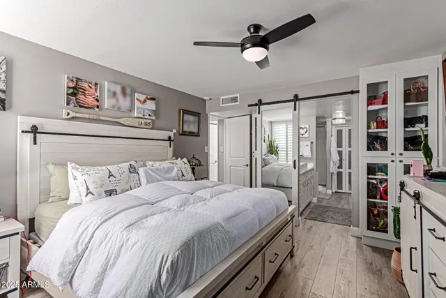 a bedroom with bed and a large mirror