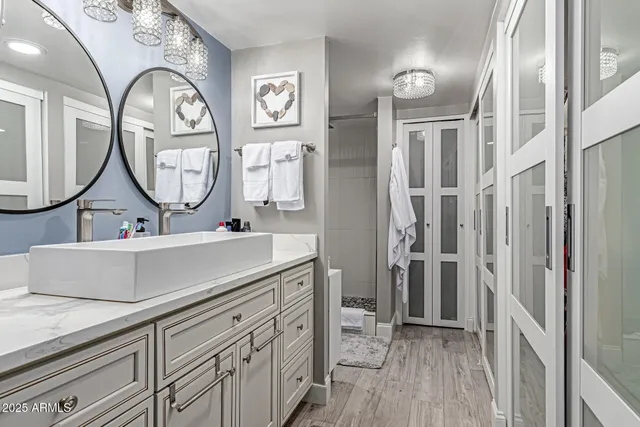 a bathroom with a double vanity sink and a mirror