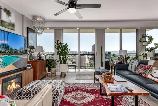 a living room with furniture a rug and a chandelier