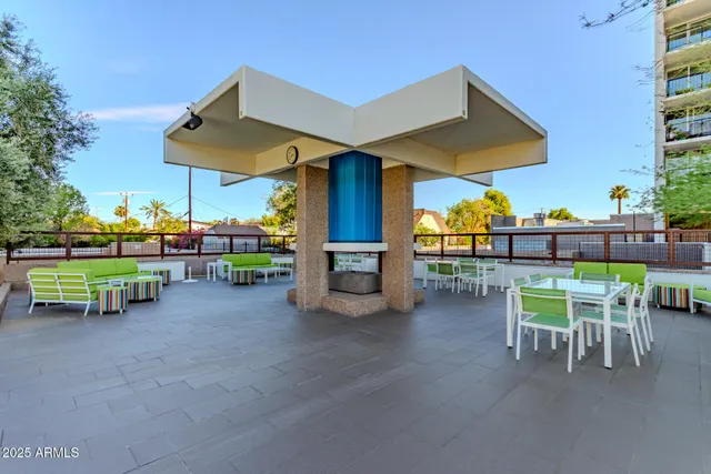 a view of a chairs and table in the back yard of the house