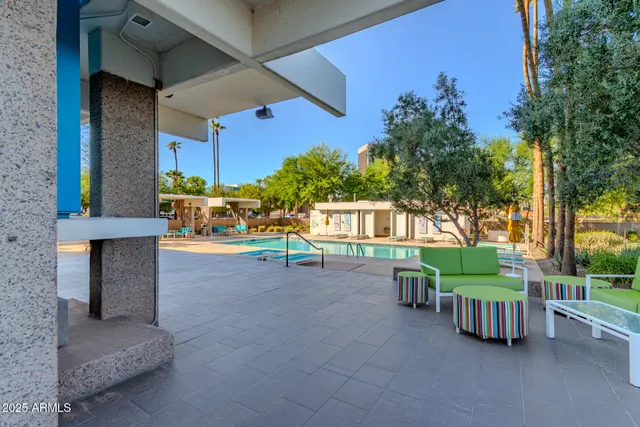 a view of a chairs and table in the back yard of the house