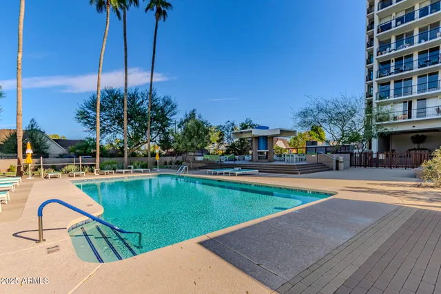 a view of a swimming pool with a lounge chairs