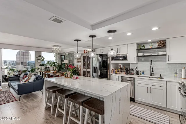 a kitchen with lots of counter top space a sink appliances and cabinets