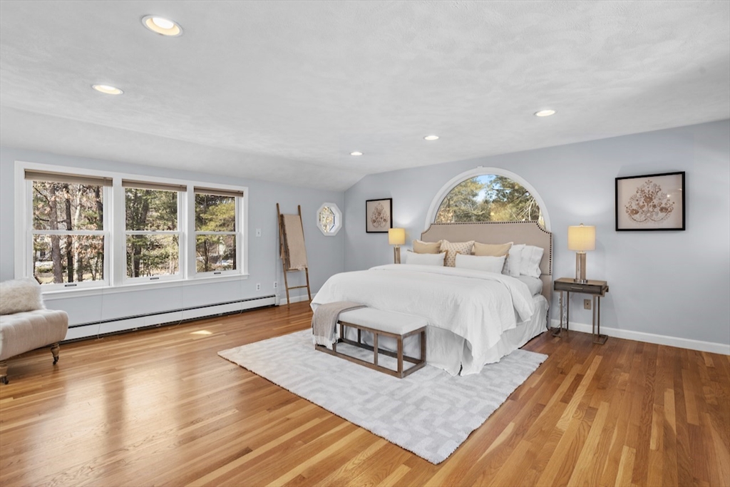 5 Madison Lane Acton, MA 01720 - Photo 14 of 26 a spacious bedroom with a bed and wooden floor