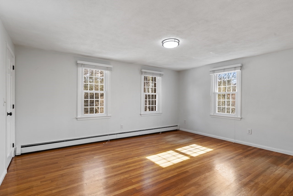 5 Madison Lane Acton, MA 01720 - Photo 18 of 26 a view of empty room with wooden floor and fan