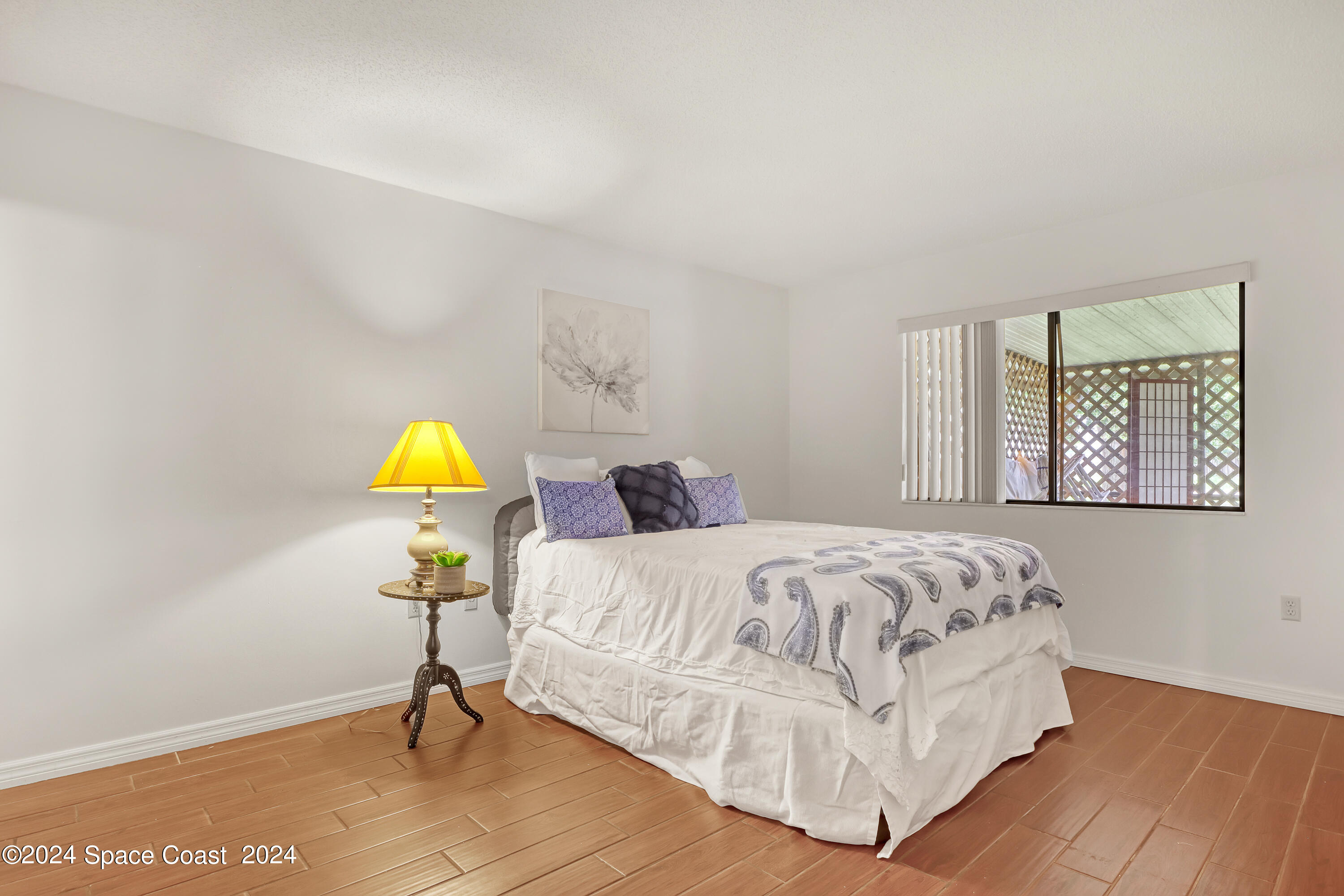 4733 Sisson Road Titusville, FL 32780 - Photo 19 of 26 a bedroom with a bed and a window