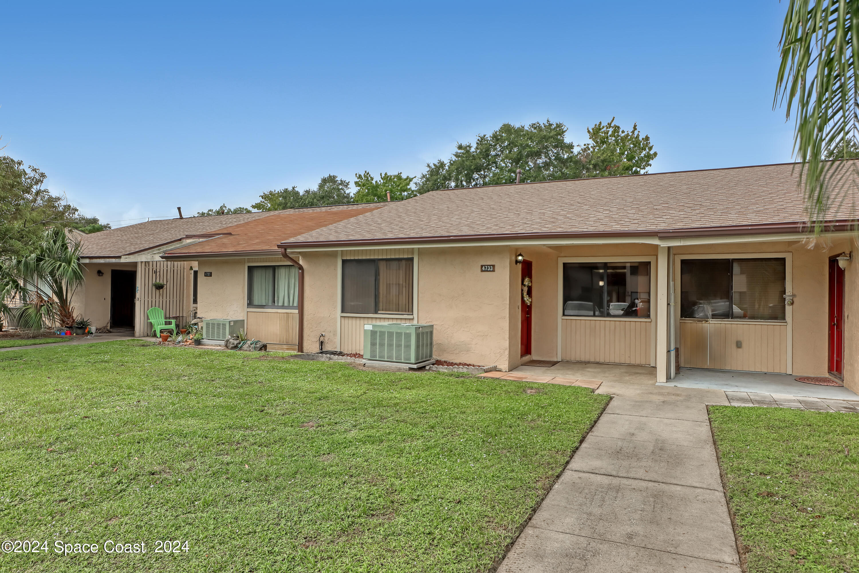 4733 Sisson Road Titusville, FL 32780 - Photo 2 of 26 a front view of house with yard and green space