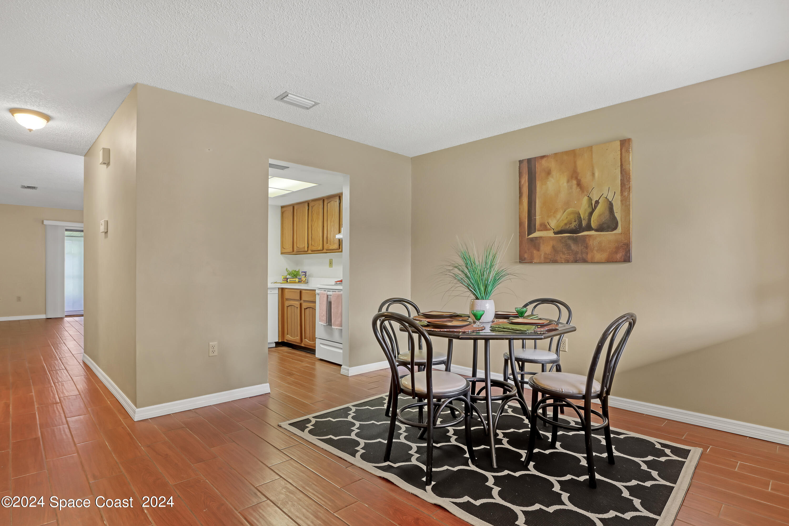 4733 Sisson Road Titusville, FL 32780 - Photo 7 of 26 a view of a dining room with furniture and wooden floor