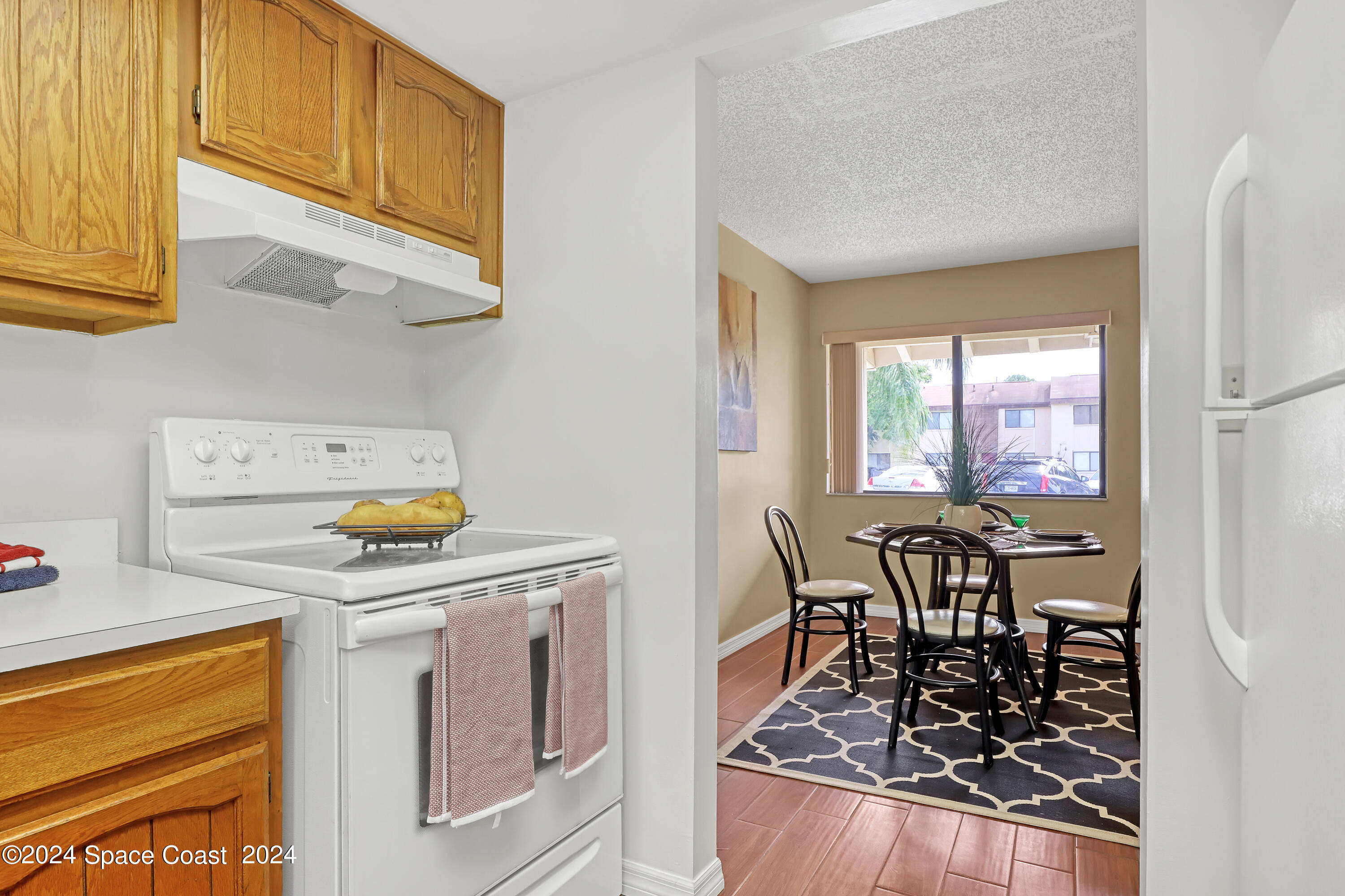 4733 Sisson Road Titusville, FL 32780 - Photo 9 of 26 a kitchen with a stove and a refrigerator