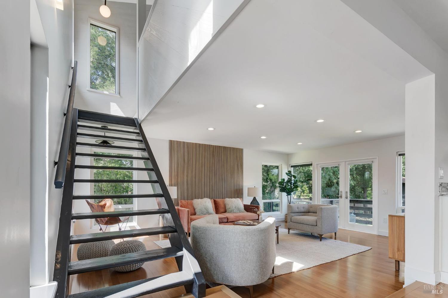 a living room with furniture and a stair