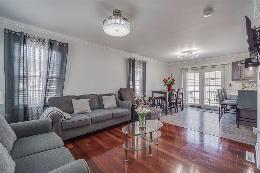 283 Christopher Drive Springfield, MA 01119 - Photo 15 of 32 a living room with furniture wooden floor and a large window