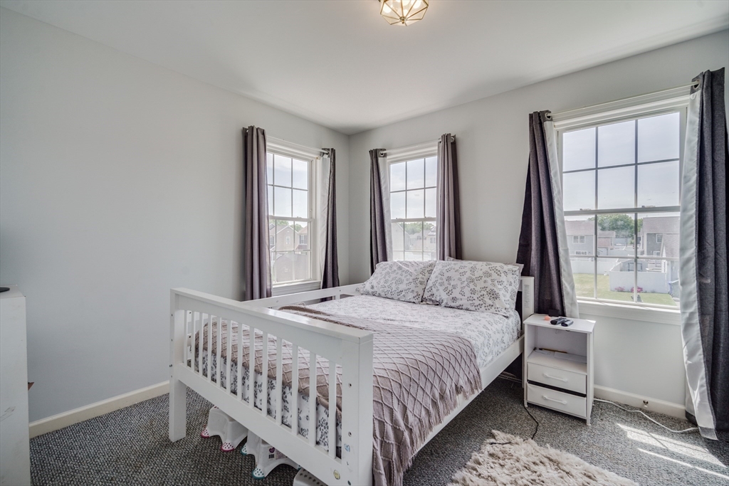 283 Christopher Drive Springfield, MA 01119 - Photo 16 of 32 a bedroom with a bed and a large window