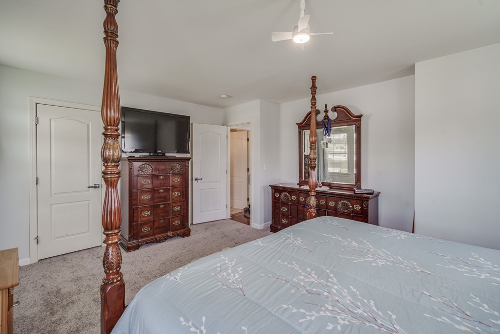283 Christopher Drive Springfield, MA 01119 - Photo 19 of 32 a bedroom with a bed and a flat screen tv
