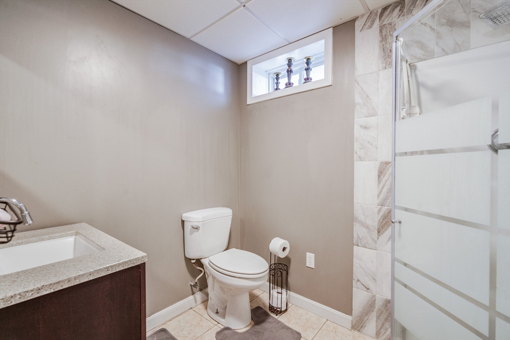 283 Christopher Drive Springfield, MA 01119 - Photo 26 of 32 a bathroom with a toilet a sink and mirror