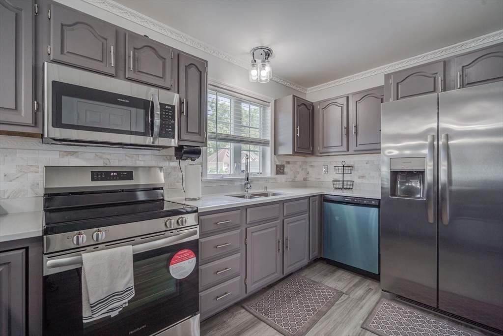 283 Christopher Drive Springfield, MA 01119 - Photo 6 of 32 a kitchen with stainless steel appliances granite countertop a stove microwave and refrigerator