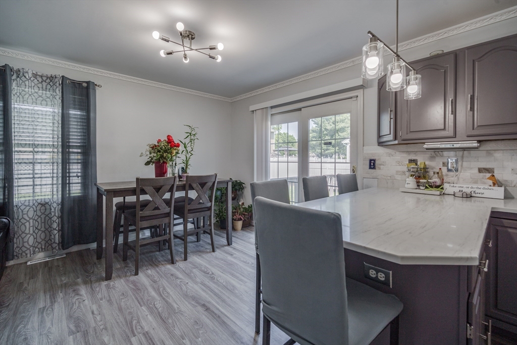 283 Christopher Drive Springfield, MA 01119 - Photo 7 of 32 a dining room with furniture a chandelier and wooden floor