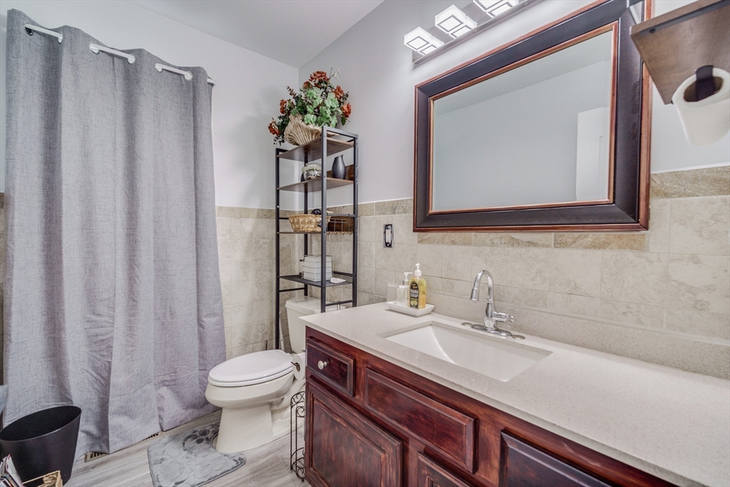 283 Christopher Drive Springfield, MA 01119 - Photo 10 of 32 a bathroom with a sink a toilet and shower curtain