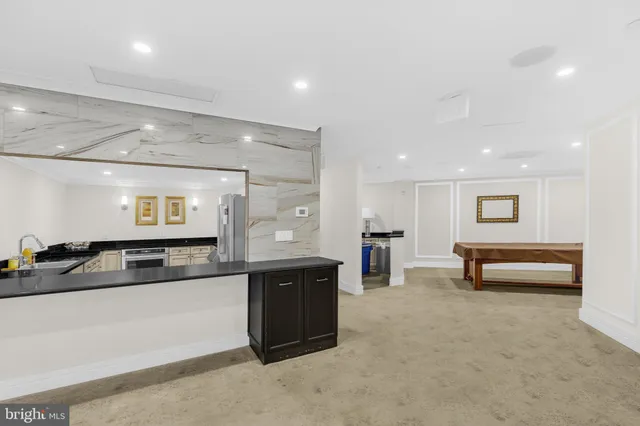 a living room with fireplace furniture and a large window