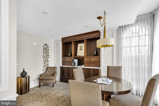 a living room with furniture a flat screen tv and a large window