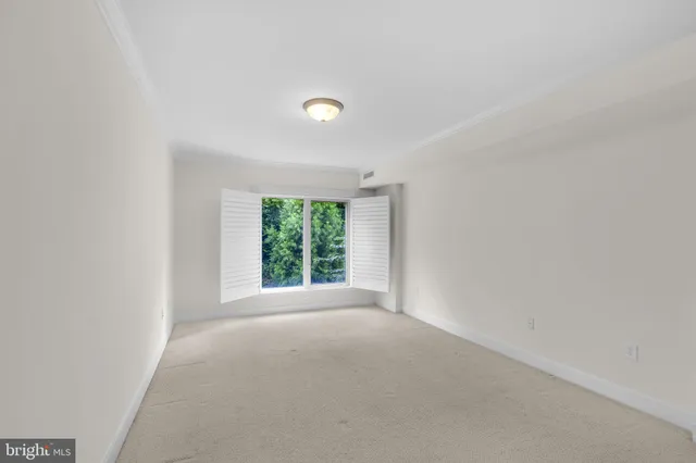 a view of a big room with windows and front door