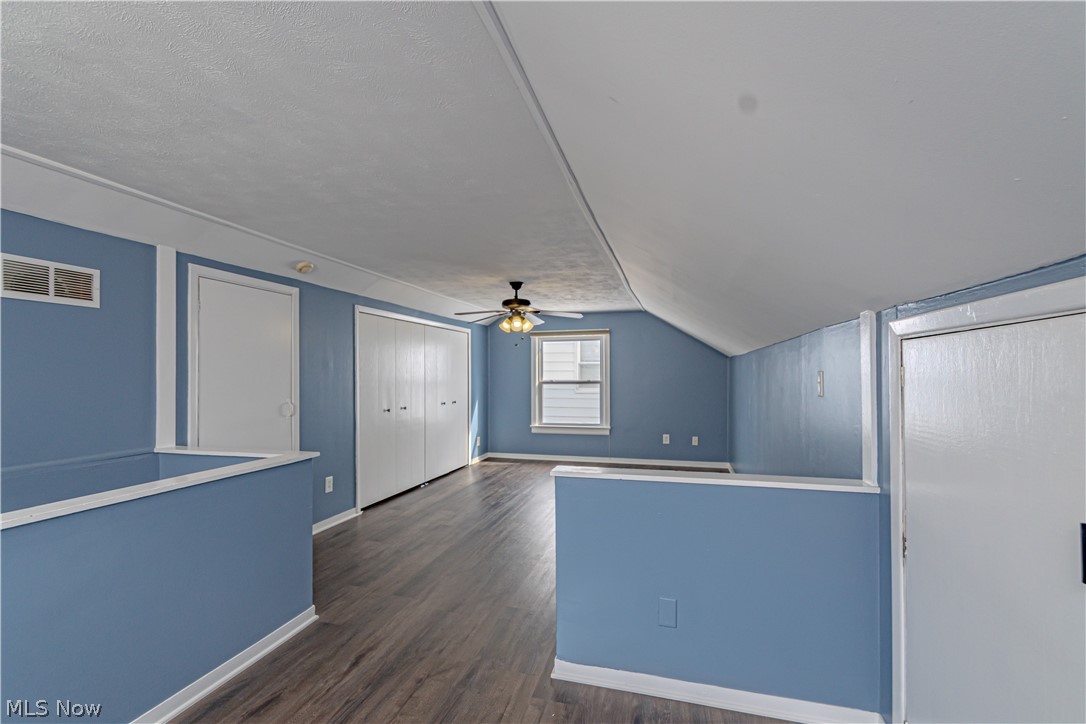 4157 Verona Road Cleveland, OH 44121 - Photo 13 of 26 Additional living space with dark wood finished floors, a ceiling fan, and vaulted ceiling