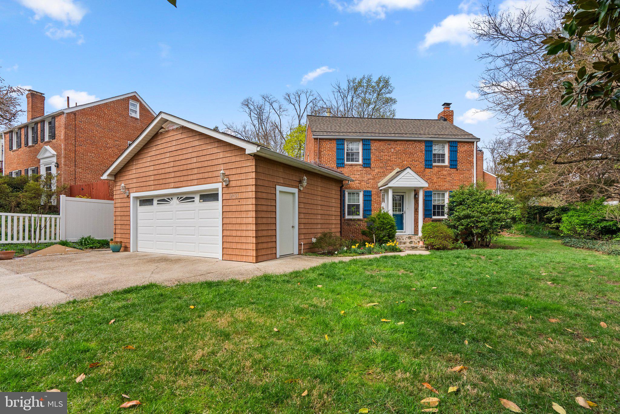 2401 Hayden Drive Silver Spring, MD 20902 - Photo 2 of 44 a front view of a house with a yard and garage