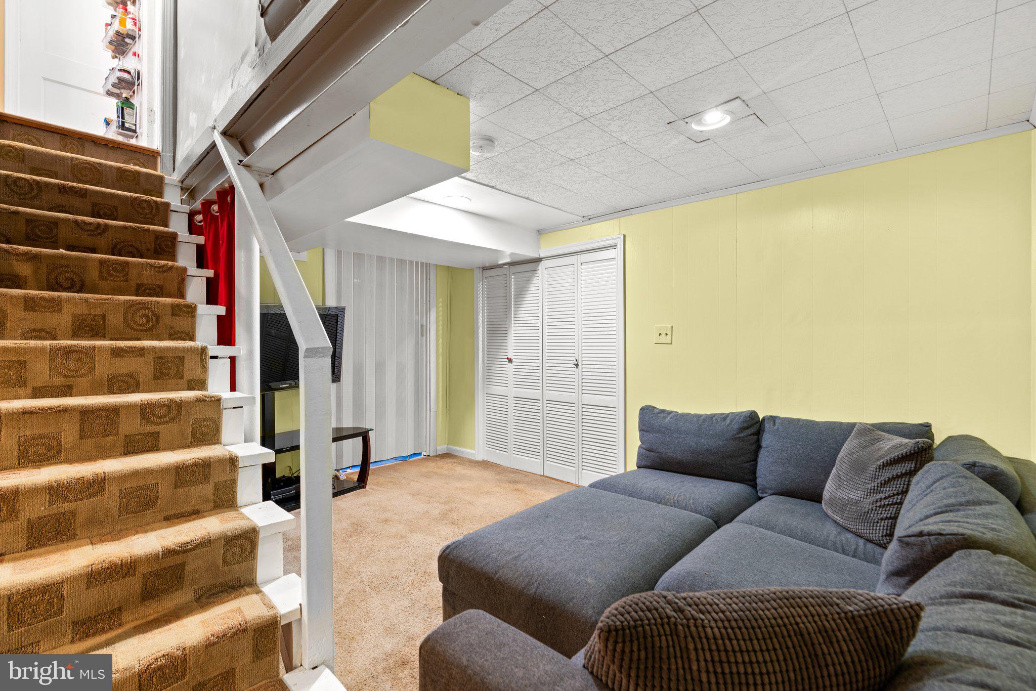 2401 Hayden Drive Silver Spring, MD 20902 - Photo 23 of 44 a living room with furniture and a flat screen tv