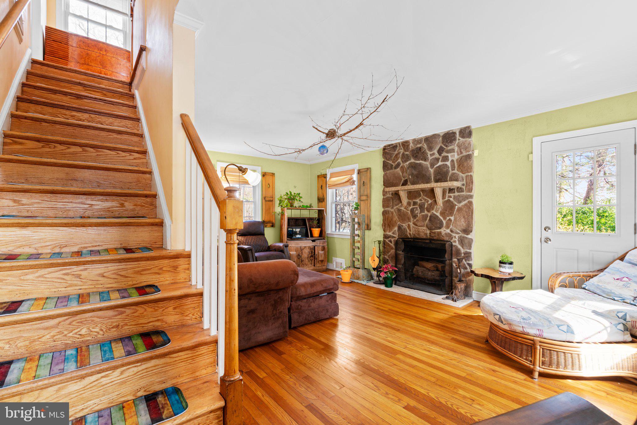 2401 Hayden Drive Silver Spring, MD 20902 - Photo 5 of 44 a view of a livingroom with furniture a fireplace and wooden floor