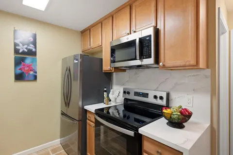 a kitchen with a refrigerator and a stove