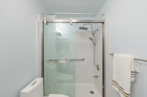 a bathroom with a shower and toilet